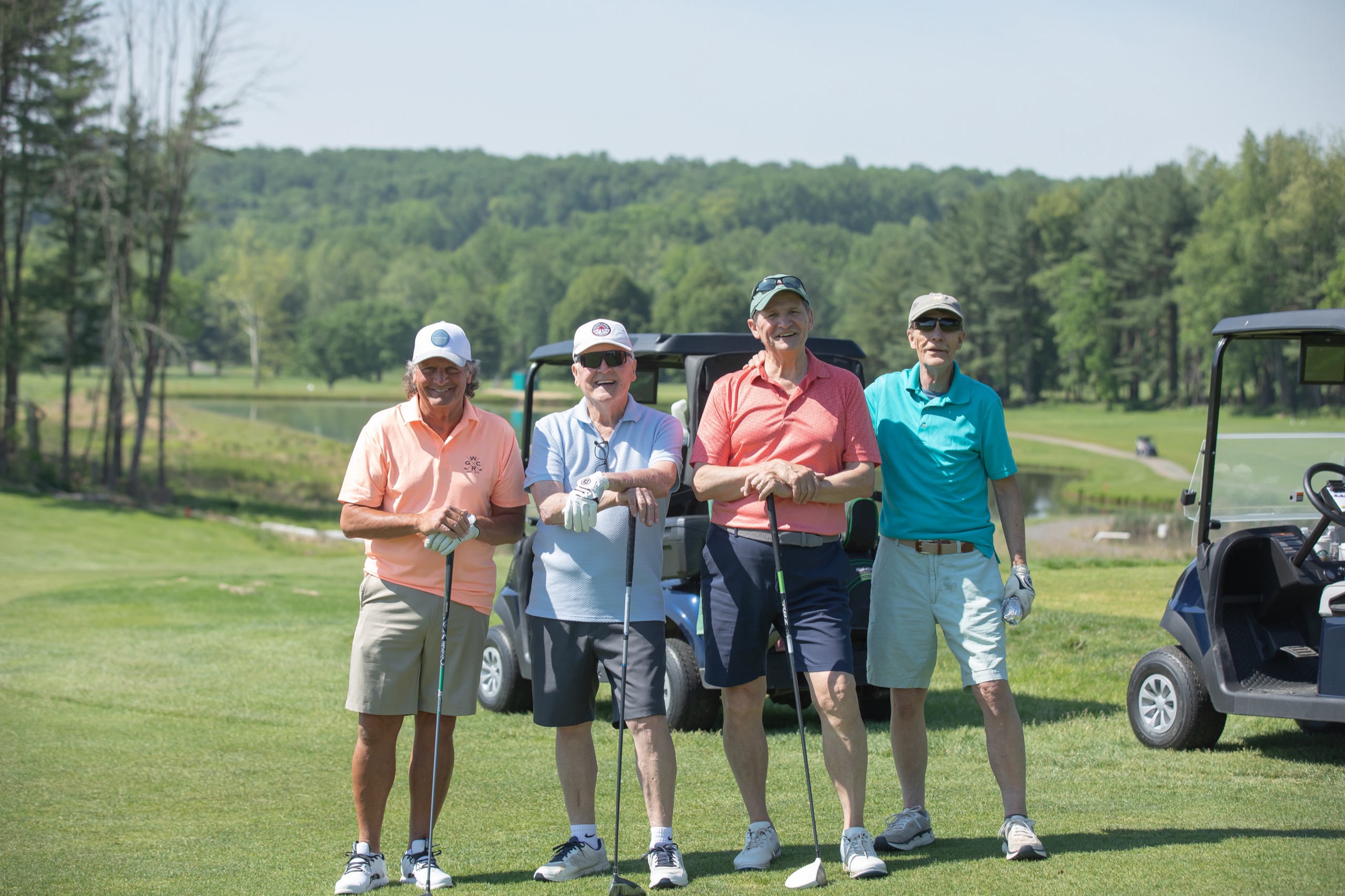 Foursome posing at a charity golf outing