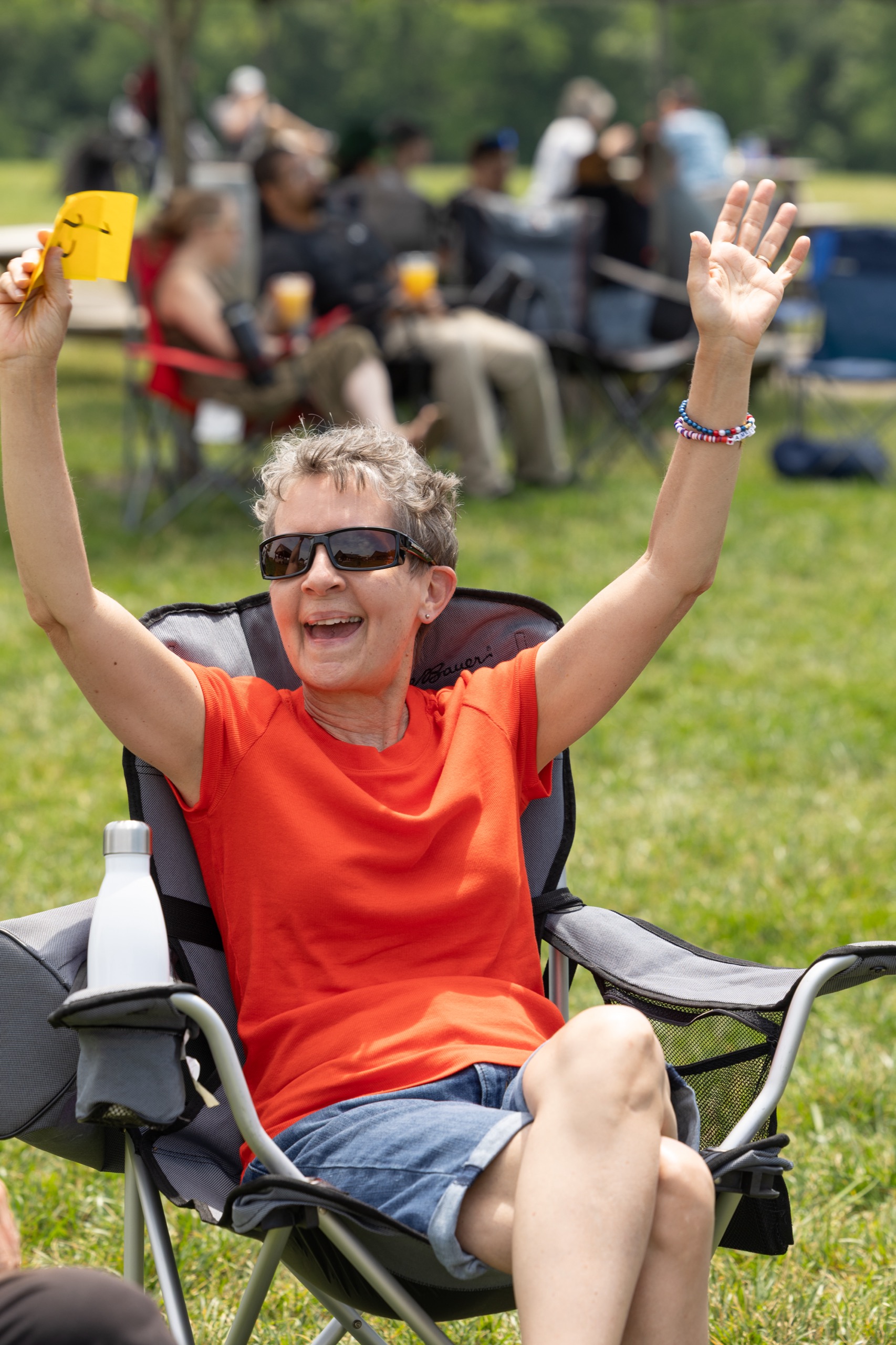 Guest cheering with arms raised at an outdoor celebration
