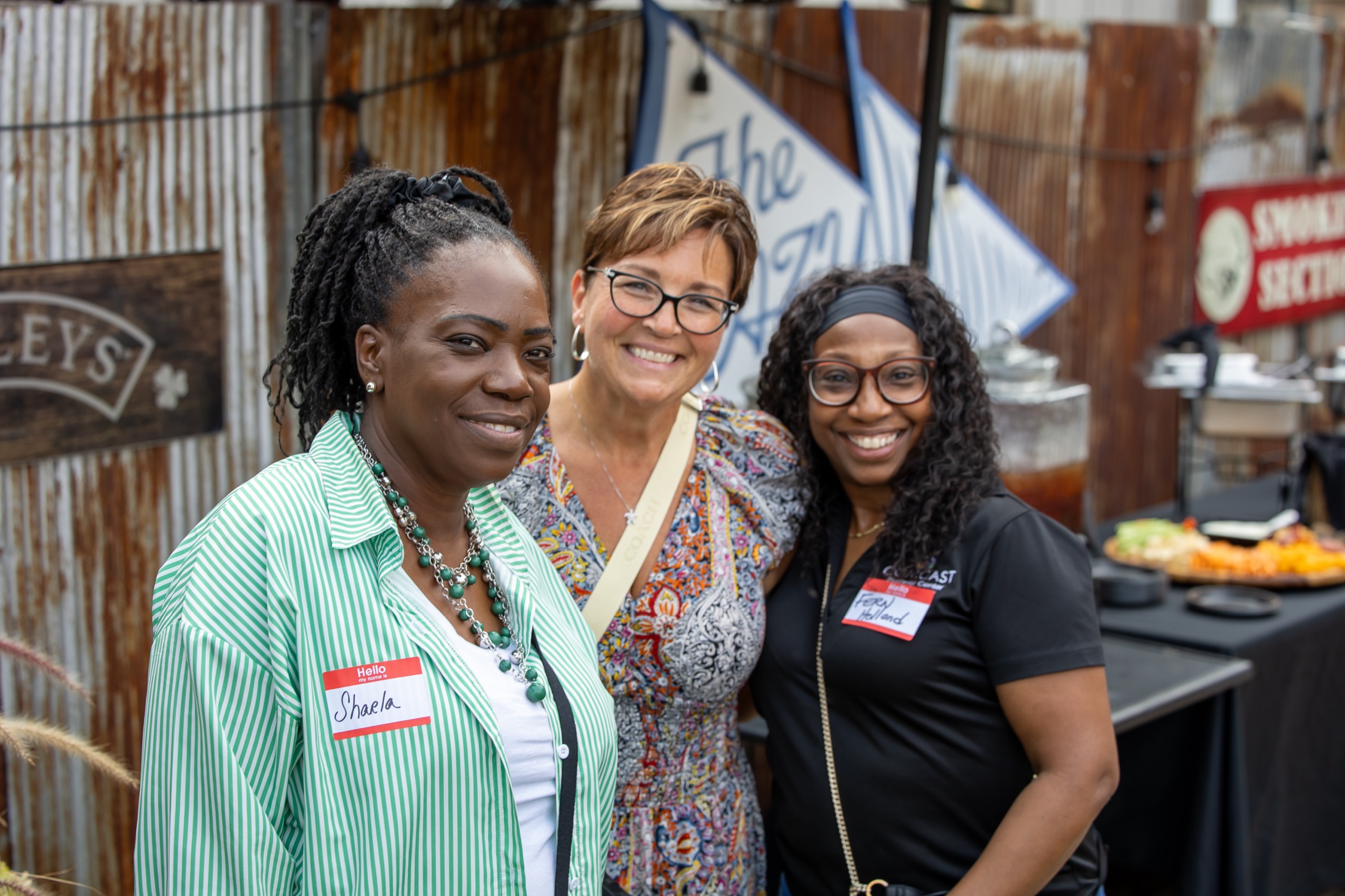 Attendees smiling together at a networking event