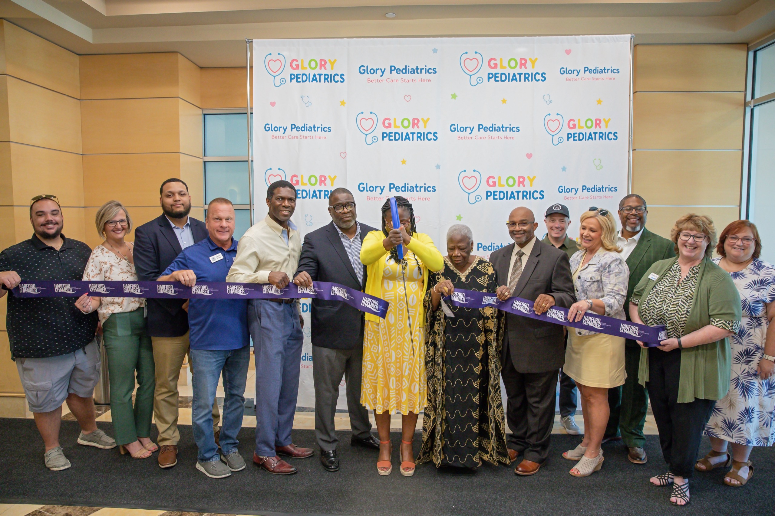 Ribbon-cutting ceremony with a large group of attendees