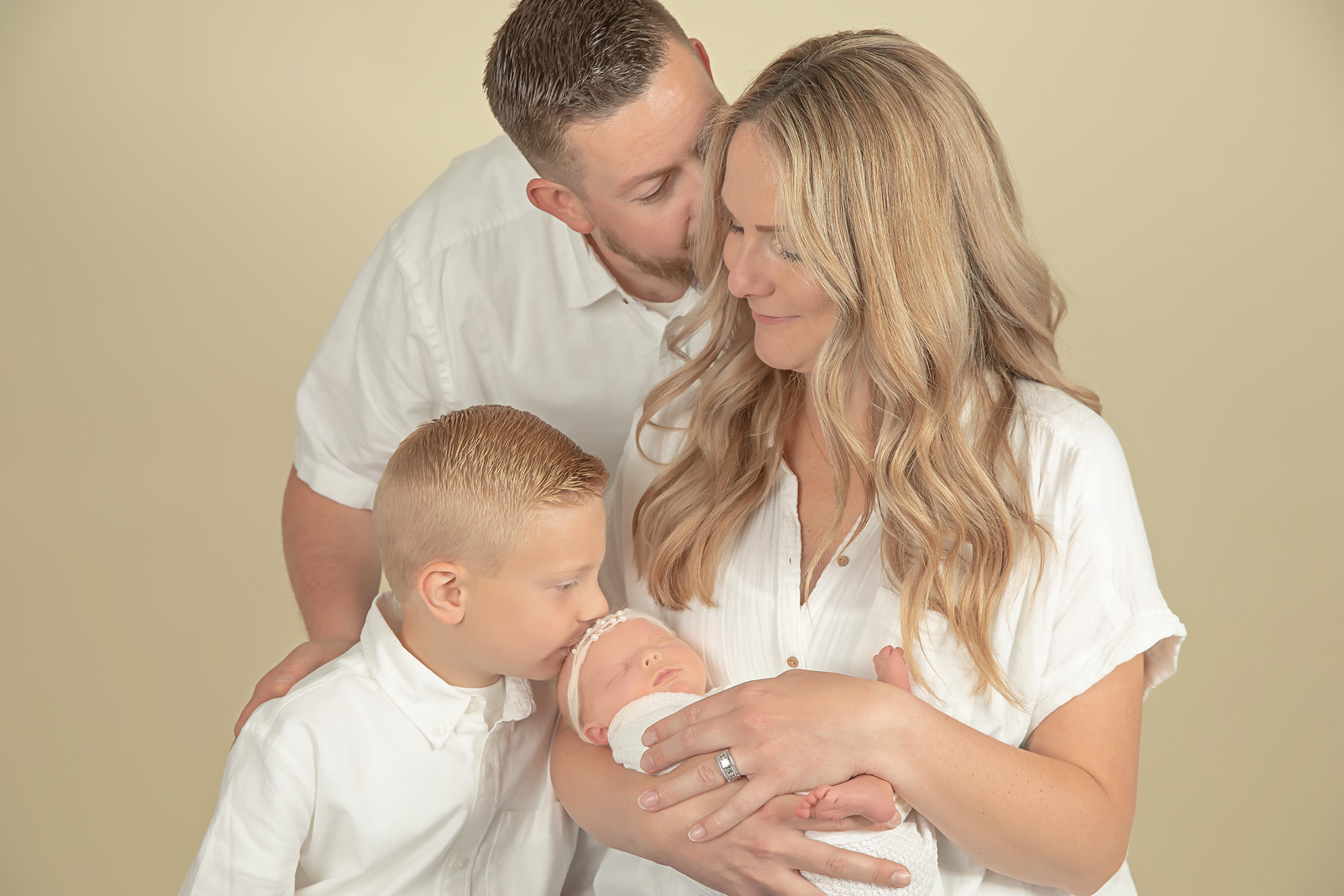 Family of four with their newborn